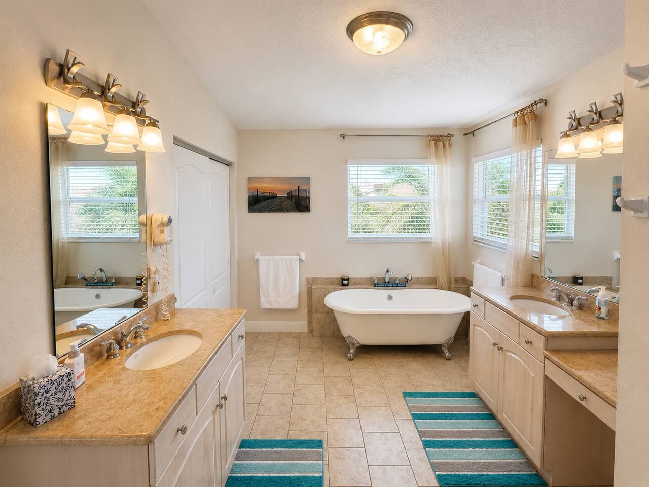 Bright spa-like bathroom with dual vanities and a soaking tub